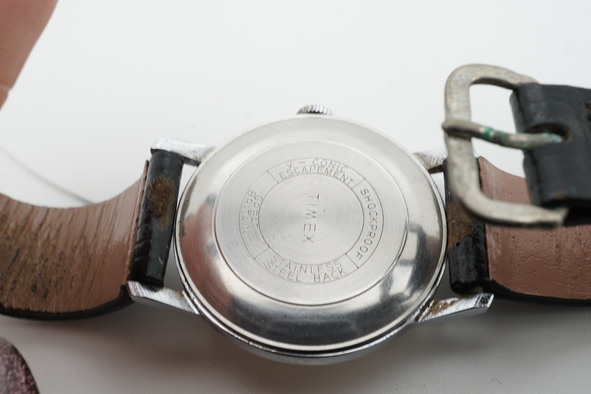 Two 1950s manual wind wrist watches; a gentleman’s stainless steel wristwatch by P. Buhre, retailed by the Goldsmiths & Silversmiths Company Ltd. case diameter 34mm, no strap, together with a Timex watch with box and pap